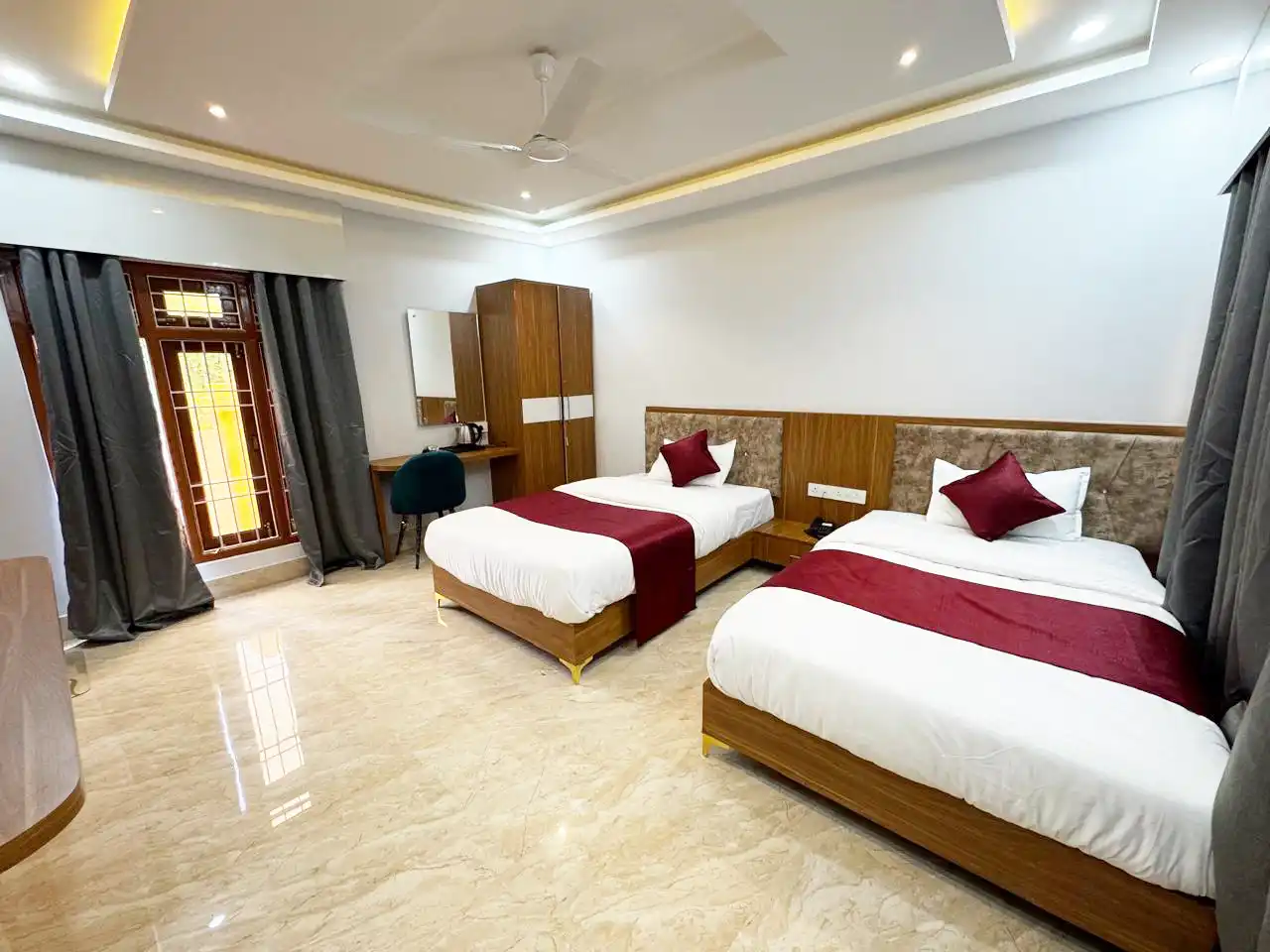 Deluxe twin-bed room with red cushions at Rivero Resort Dirang